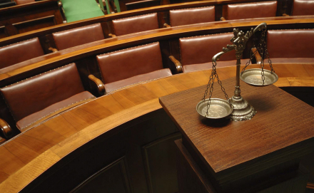 Image of a courtroom with the scales of justice