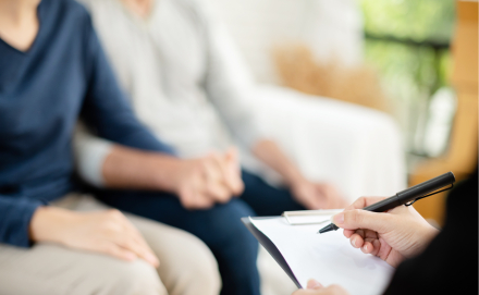 Young man and woman consulting with professional consultant.