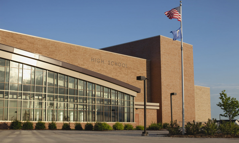 Exterior Image of a High School with a Flag Pole